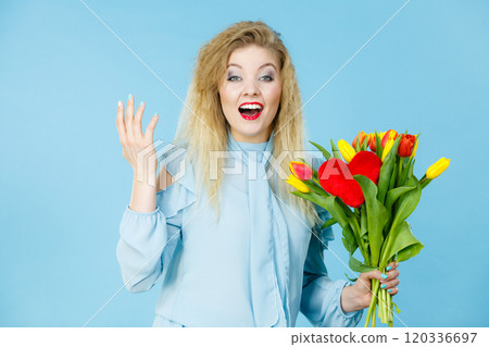 Pretty woman with red yellow tulips bunch 120336697