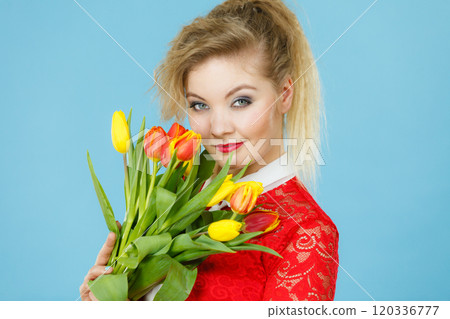 Pretty woman with red yellow tulips bunch 120336777