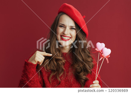 smiling stylish 40 years old woman in red sweater and beret smiling stylish 40 years old woman in red sweater and beret 120336989