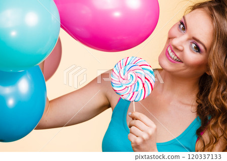 Woman with colorful balloons and lollipop Woman with colorful balloons and lollipop 120337133