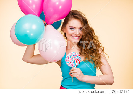 Woman with colorful balloons and lollipop 120337135