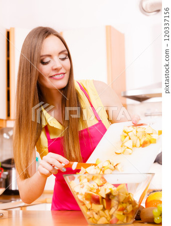 Woman housewife in kitchen cutting apple fruits 120337156