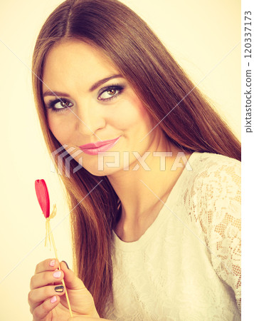 Beautiful woman holding heart shaped hand stick Beautiful woman holding heart shaped hand stick 120337173