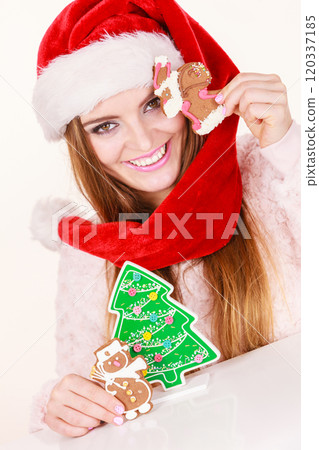 Woman santa claus hat with gingerbread cookies. Christmas Woman santa claus hat with gingerbread cookies. Christmas 120337185
