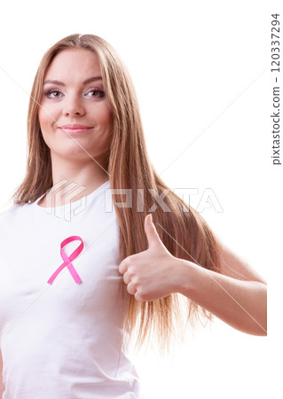 woman pink cancer ribbon on chest making thumb up 120337294