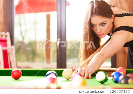 Young woman playing billiard. Young woman playing billiard. 120337323