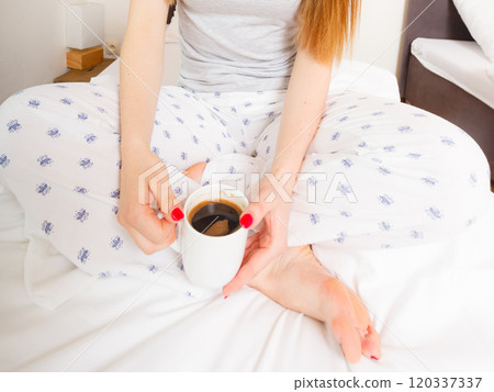 Cheerful girl drinking coffee. 120337337