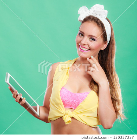 Pin up fashion girl browsing internet on pc tablet Pin up fashion girl browsing internet on pc tablet 120337357