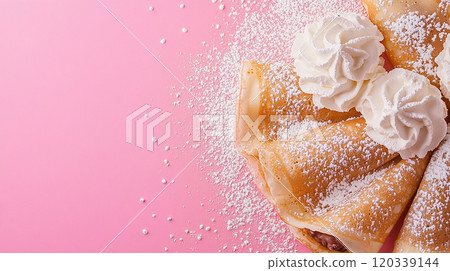 Crepes topped with whipped cream and powdered sugar 120339144