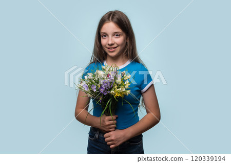 Young girl holding colorful bouquet of flowers Young girl holding colorful bouquet of flowers 120339194