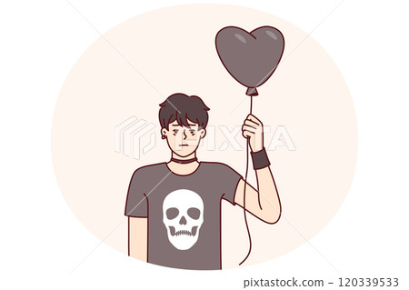 Guy teenager in goth clothes holds black balloon in form of heart for girl he likes from school 120339533