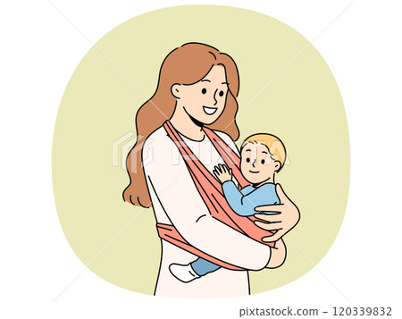 Mother holds baby in carrier sling and smiles, taking care of son and using comfortable babywearing. 120339832