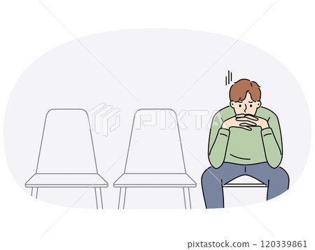 Sad man is waiting for start of interview, sitting in office corridor with empty chairs 120339861