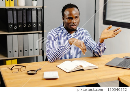 Professional man working on laptop at desk 120340352
