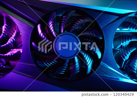 Close-up of high-performance graphics card with cooling fans illuminated by neon lighting. Modern video card for gaming and advanced computing Close-up of high-performance graphics card with cooling fans illuminated by neon lighting. Modern video card for gaming and advanced computing 120340429