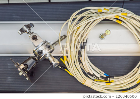 Video production gear on a set - big cinema lights and light rigging system. Video production gear on a set - big cinema lights and light rigging system. 120340500