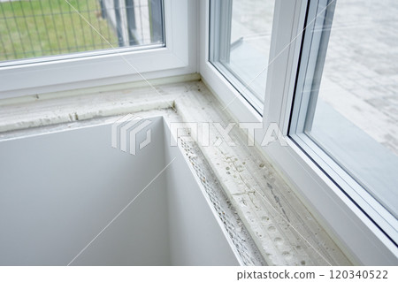 Process of renovation in new apartment, installing sill in modern pvc window Process of renovation in new apartment, installing sill in modern pvc window 120340522