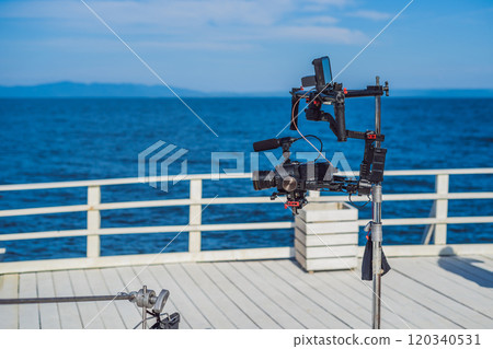 profeccional cinema camera on a 3-axis camera stabilizer system on a commercial production set profeccional cinema camera on a 3-axis camera stabilizer system on a commercial production set 120340531