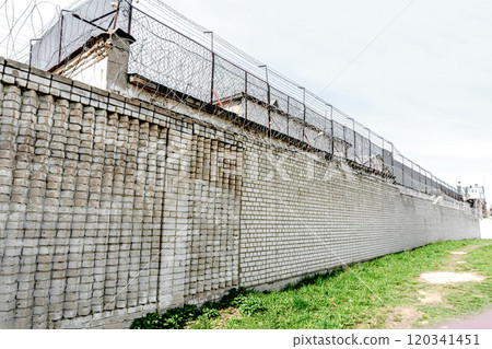 Brick Prison Wall with Barbed Wire Brick Prison Wall with Barbed Wire 120341451