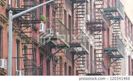 New York City building architecture, Manhattan. Residential house exterior. Red brick, fire escape. 120341468