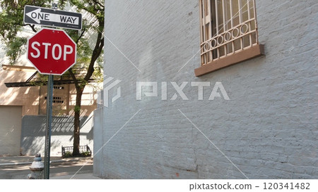 New York City oneway crossroad, Minetta street intersection, one way, red stop road sign. Manhattan. 120341482