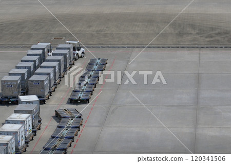 Working cars at the airport Container dollies lined up 120341506