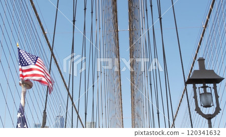 American flag on Brooklyn Bridge to Manhattan, New York City. Patriotic symbol. Travel USA. 120341632