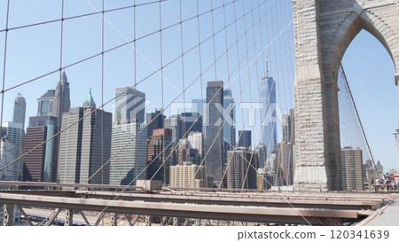 Brooklyn Bridge cables, Manhattan downtown. New York City skyline, financial district cityscape. 120341639