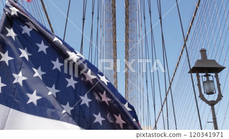 American flag on Brooklyn Bridge to Manhattan, New York City. Patriotic symbol. Travel USA. American flag on Brooklyn Bridge to Manhattan, New York City. Patriotic symbol. Travel USA. 120341971