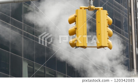 Steam vapor vented, New York City street steam system, orange vapour tube stack. Hot smoke from pipe Steam vapor vented, New York City street steam system, orange vapour tube stack. Hot smoke from pipe 120342085