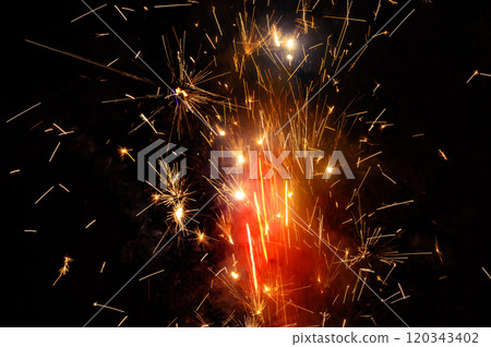 close up burning flare or flame with bright sparks and smoke on background with copy space. festive event concept. fireworks exploding at night. 120343402