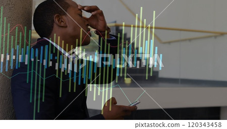 Image of diagrams over biracial businessman using smartphone 120343458