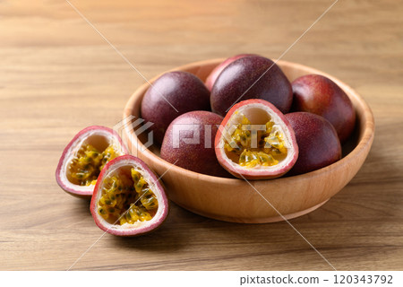 Passion fruit in bowl on wooden background, Tropical fruit 120343792