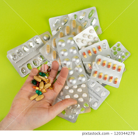 Hand with Color Pill Capsules on Green Background, Overdose Concept, Opioid Problem, Poison, Analgesic Hand with Color Pill Capsules on Green Background, Overdose Concept, Opioid Problem, Poison, Analgesic 120344279
