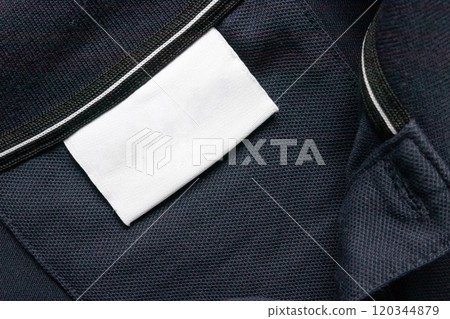 Blank white laundry care clothes label on black shirt fabric texture background Blank white laundry care clothes label on black shirt fabric texture background 120344879