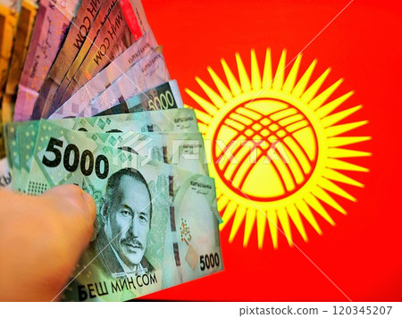 Kyrgyz som banknotes in front of National flag of Kyrgyzstan Kyrgyz som banknotes in front of National flag of Kyrgyzstan 120345207