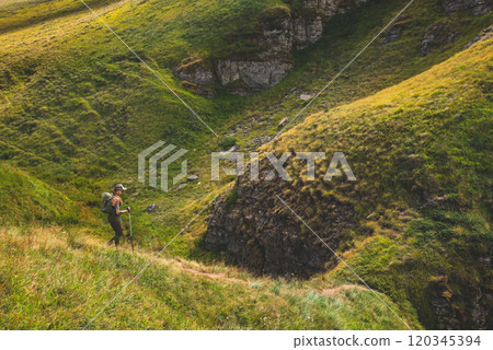 Woman Tourist Hiking Alone in Summer Mountains Woman Tourist Hiking Alone in Summer Mountains 120345394