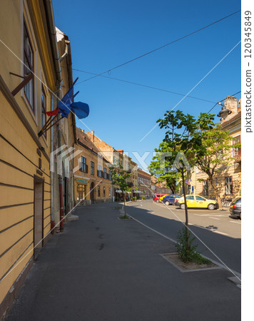 sibiu, romania - jun 25, 2017: narrow streets of sibiu city center. culture trip. architectural heritage on a sunny day. popular travel destination of romania. typical europe sibiu, romania - jun 25, 2017: narrow streets of sibiu city center. culture trip. architectural heritage on a sunny day. popular travel destination of romania. typical europe 120345849