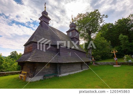 likitsary, transcarpathia, ukraine - jul 02, 2020: st. vasyl wooden church in carpathian mountains. scenic dome. sunny summer day. holy environment likitsary, transcarpathia, ukraine - jul 02, 2020: st. vasyl wooden church in carpathian mountains. scenic dome. sunny summer day. holy environment 120345863