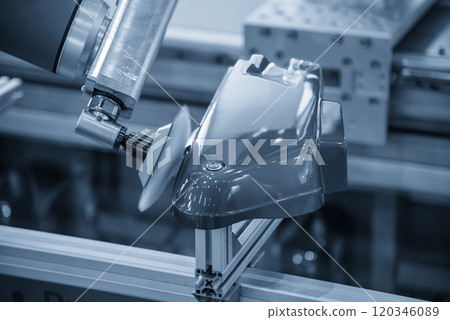 The automotive parts polishing process by robotic system in the light blue scene. 120346089