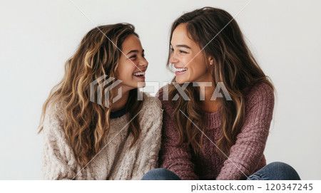 Studio portrait of smiling mother and teenage daughter - family bonding concept 120347245