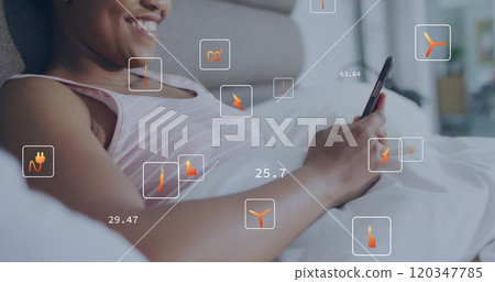 Image of ecology icons and data over biracial woman using smartphone in bed 120347785