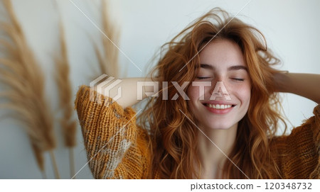 Close-up of the face of a smiling red-haired girl with curly hair on a white background Close-up of the face of a smiling red-haired girl with curly hair on a white background 120348732