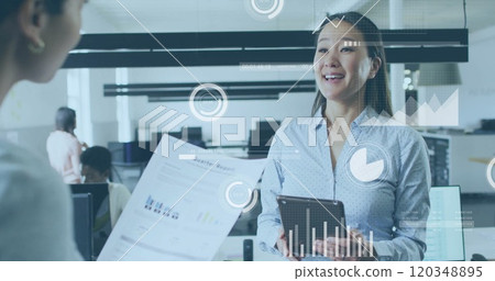 Image of financial data processing over diverse colleagues discussing work in office Image of financial data processing over diverse colleagues discussing work in office 120348895