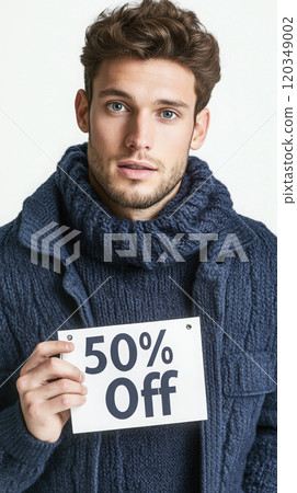 Confident male model displaying 50% off sign for promotional campaign design 120349002