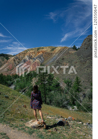 young woman in short dress stands against backdrop of famous landmark Altai Mars 120350647