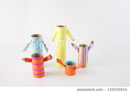 step in creative DIY project, empty cardboard rolls and tubes transformed into The bodies, are wrapped in different colored and patterned paper, and the arms are made from paper as well 120350914