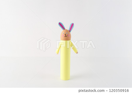 handmade bunny craft made from cardboard tube, an egg-shaped head with drawn-on facial features and paper ears. The bodies are wrapped colored paper, Easter decorations or kids art projects, 120350916