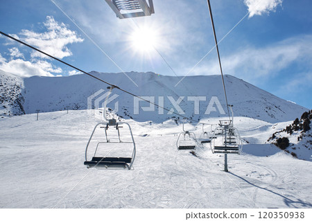 Skilift construction. Empty cable car on mountain slope at ski resort. Winter 120350938