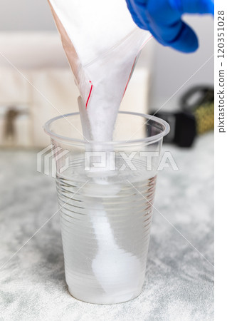 Pouring Glucose Powder into Water for Glucose Tolerance Test Pouring Glucose Powder into Water for Glucose Tolerance Test 120351028